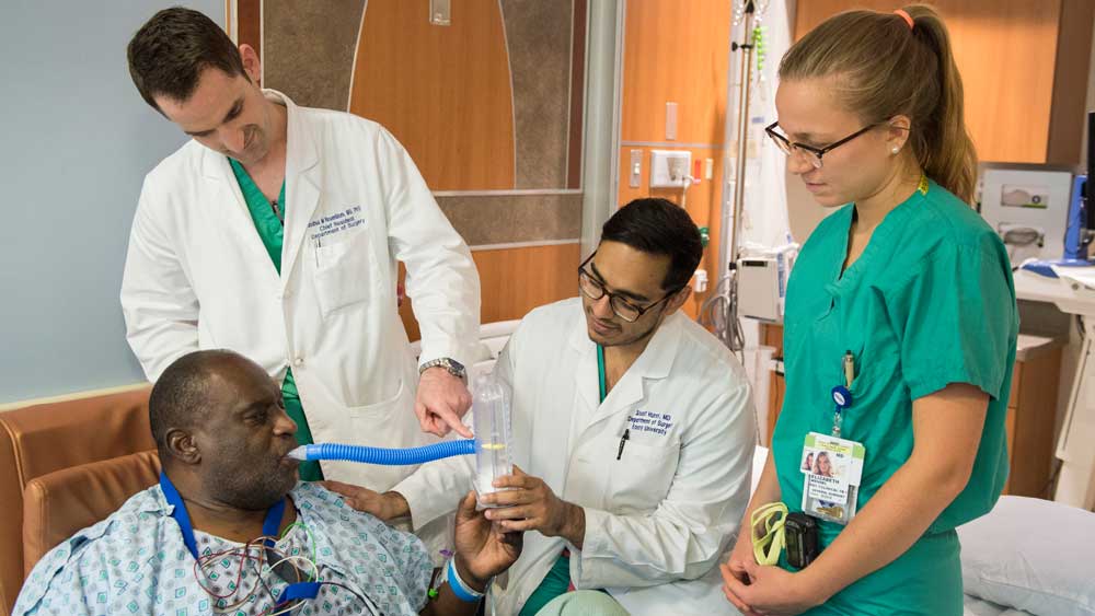 Surgery residents doing patient rounds.