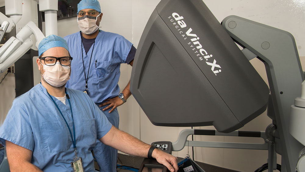 Surgeons with robot.