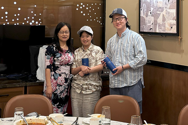 Dr. Yu wishes Qi and Xianglin great work in their Ph.D. program study at the farewell party. May 2025