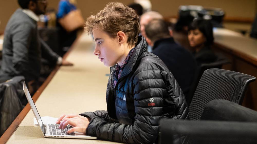 male typing on a laptop