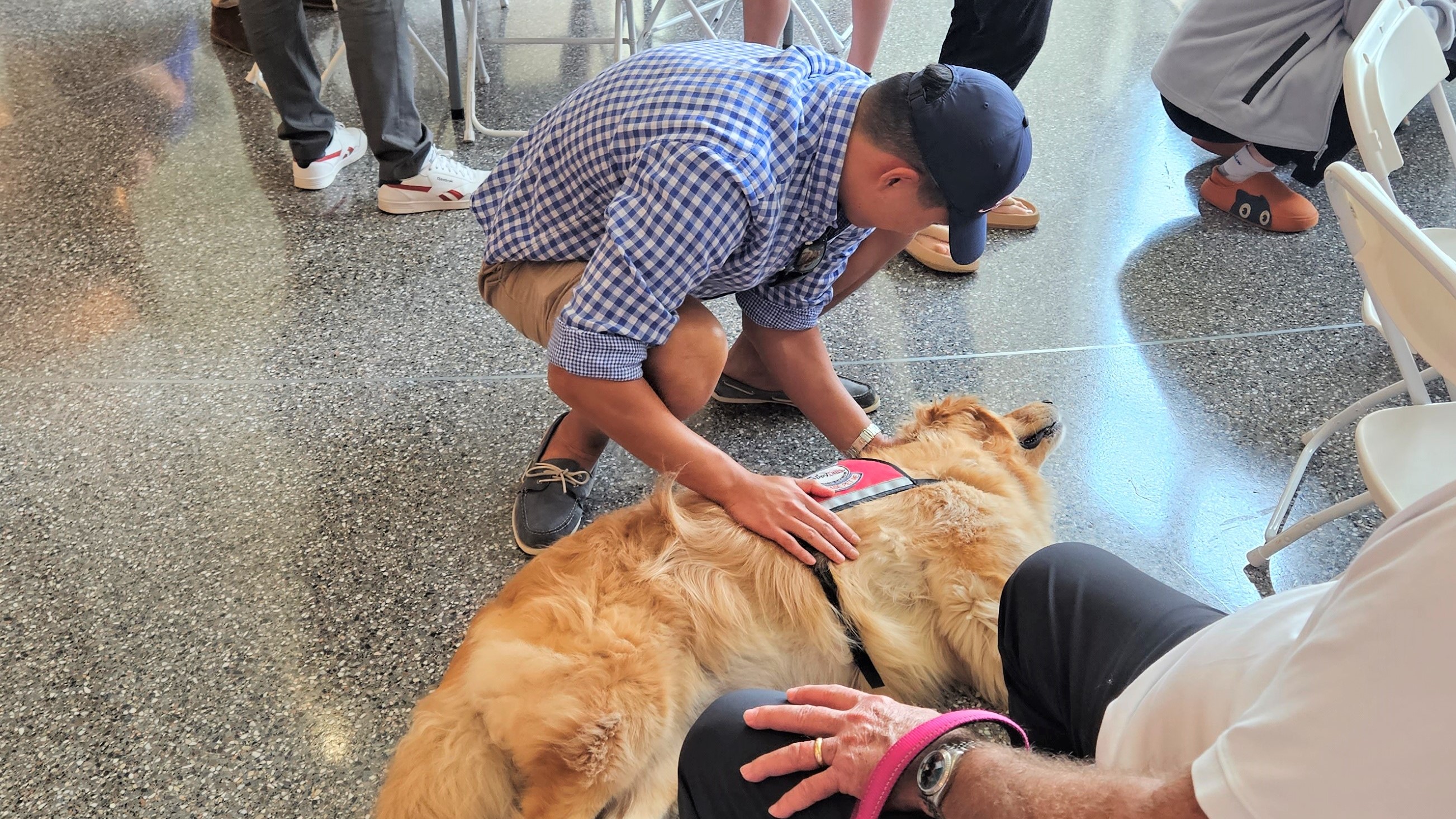 student petting dog