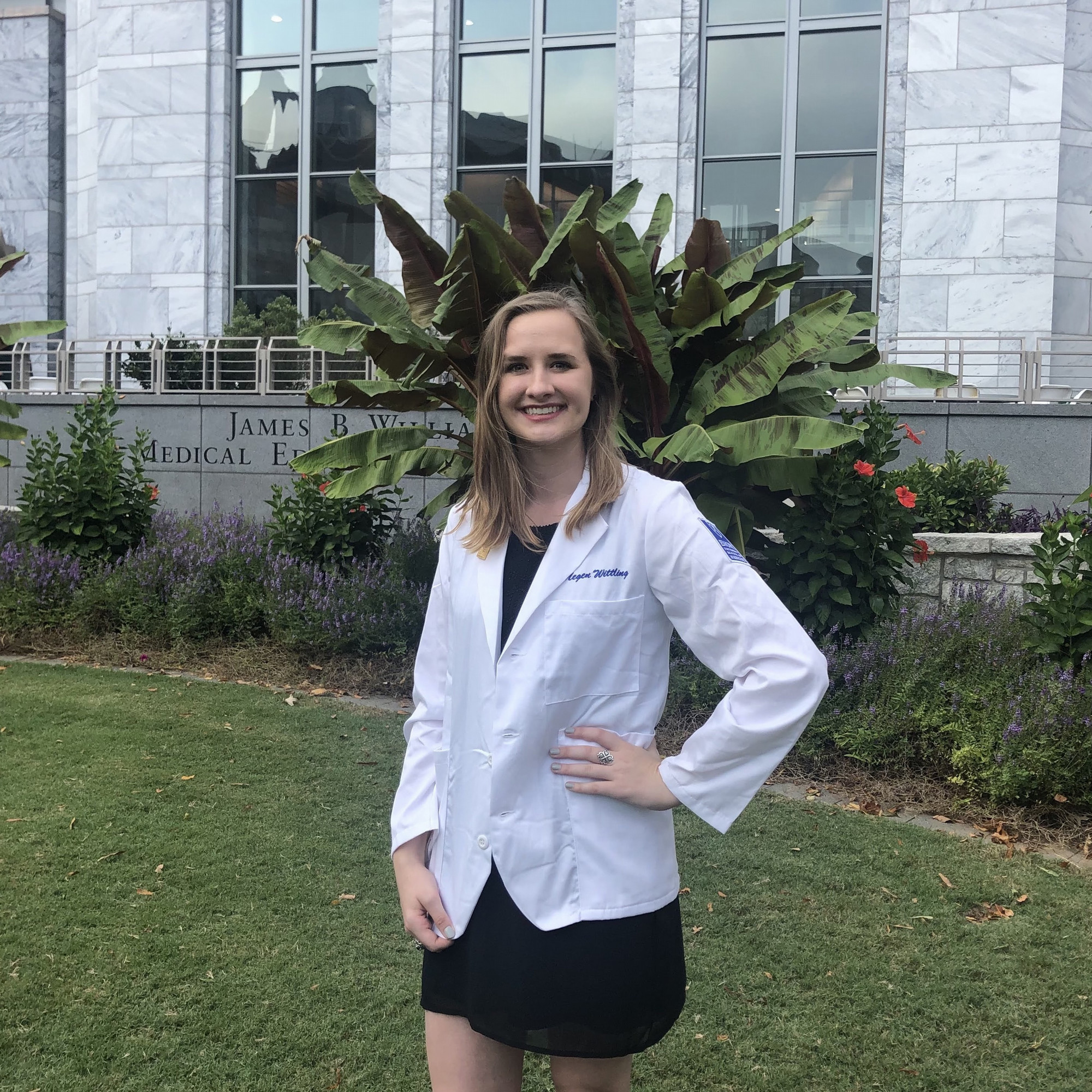 megen standing in front of the Emory school of medicine