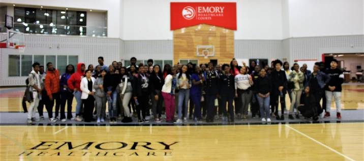 Group of high school students posed on staircase outside