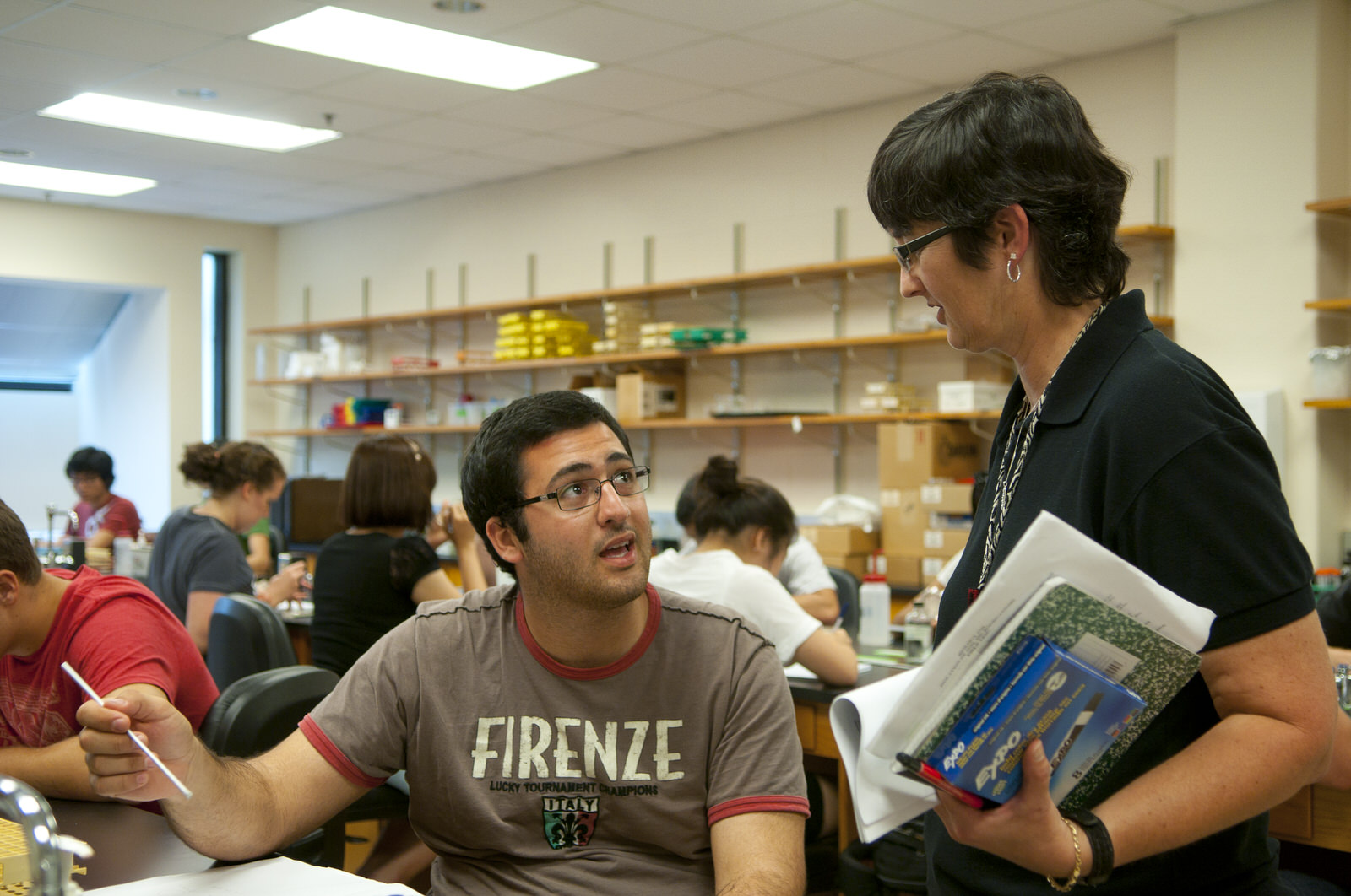 Students and faculty sitting in a window