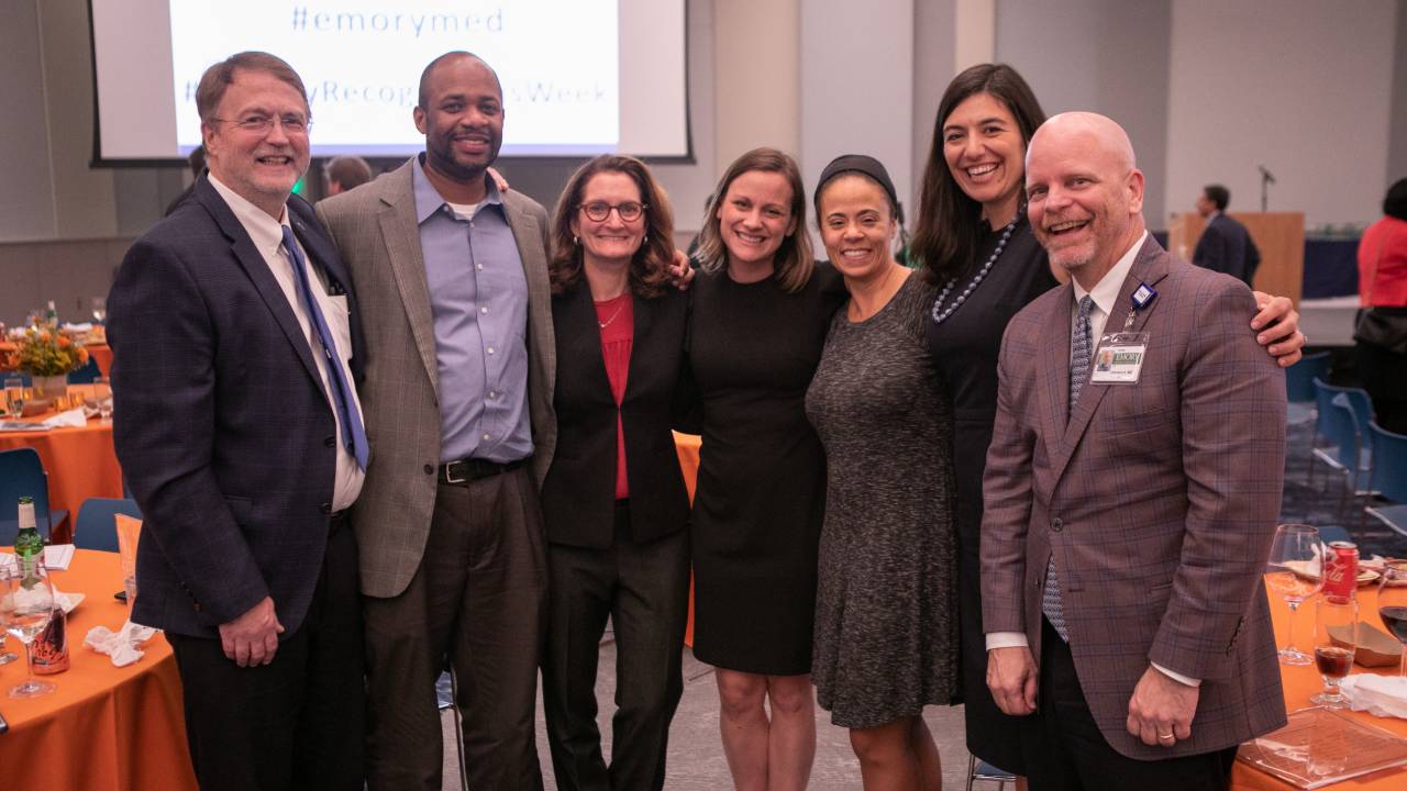 group shot of 7 faculty members smiling