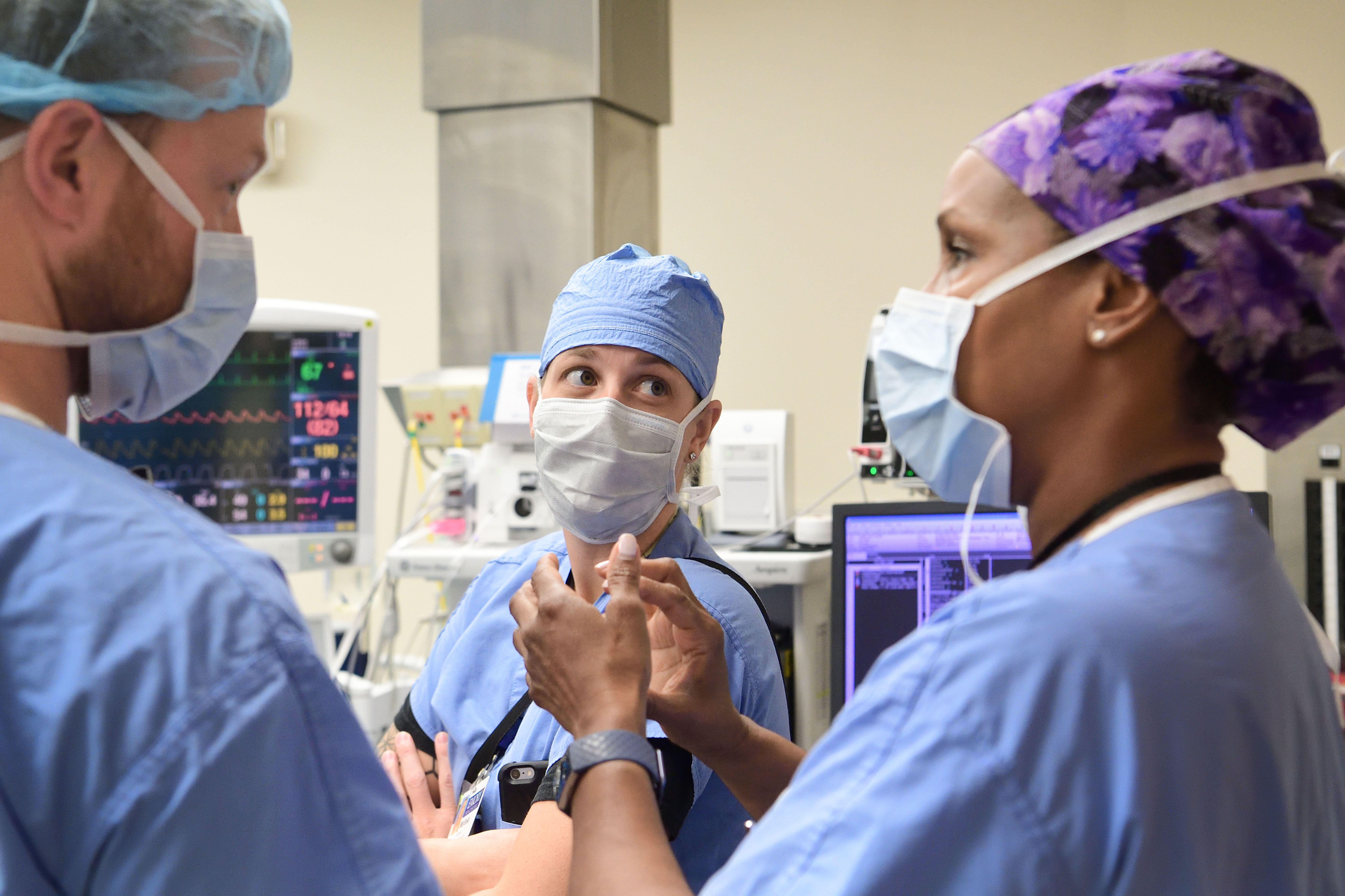 Students with faculty member rounding at bedside