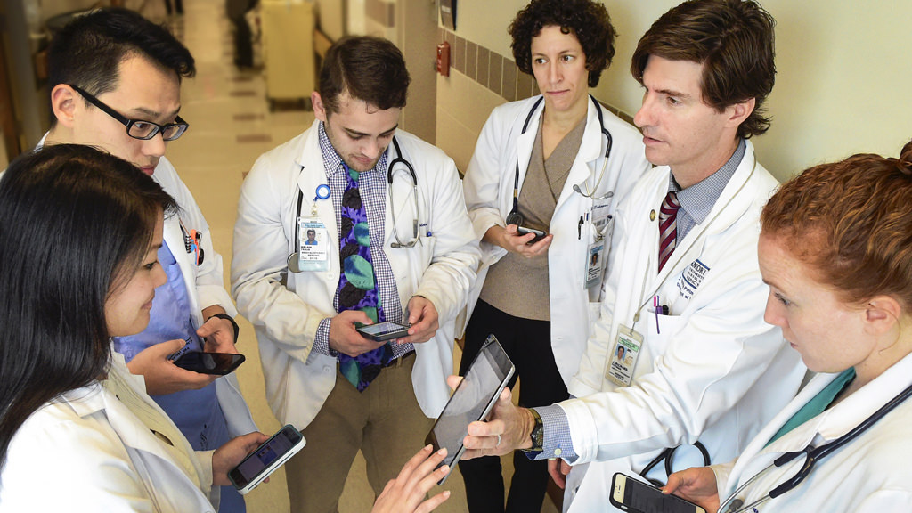 Faculty and students in hospital hallway