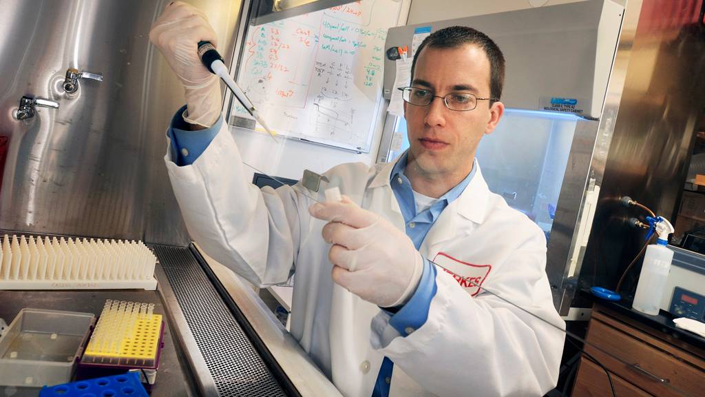 scientist in lab with pipette 